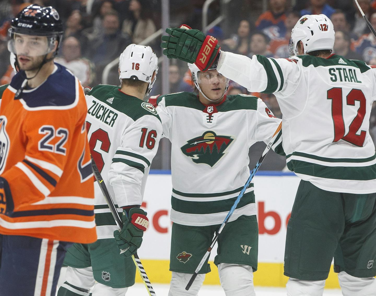 Minnesota Wild' Jason Zucker (16), Mikael Granlund (64) and Eric Staal (12) celebrate a goal as Edmonton Oilers' Tobias Rieder (22) skates past during third period NHL hockey action in Edmonton, Alberta, on Tuesday, Oct. 30, 2018. (Jason Franson/The Canadian Press via AP)