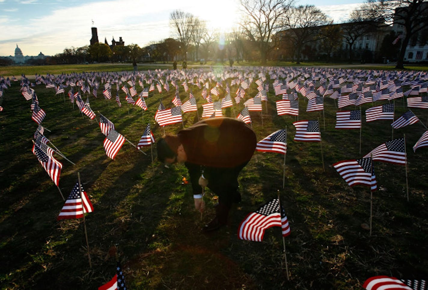 WASHINGTON - NOVEMBER 30: Antonio Agnone helps to plant hundreds of American flags displayed on the National Mall as part of a campaign by gay rights lobbying groups including the Log Cabin Republicans, Liberty Education Forum, Servicemembers Legal Defense Network, and the Human Rights Campaign November 30, 2007 in Washington, DC. The groups planted the flags on the anniversary of the signing of the "Don't Ask Don't Tell" law, with one American flag for each soldier discharged from military serv