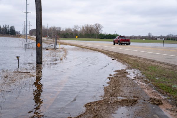 Floodwaters encroach on the edge of County Road 17 on Wednesday, April 19, 2023, in Delano, Minn.