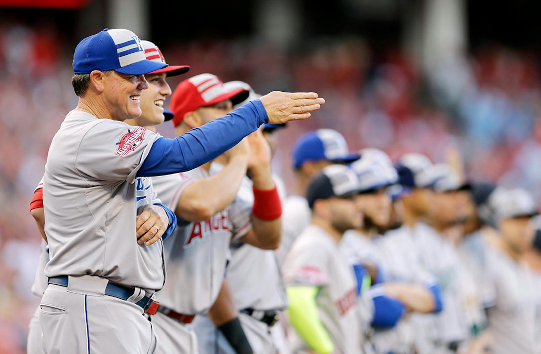 American League manager Ned Yost, of the Kansas City Royals, gestures after being introduced before the MLB All-Star baseball game, Tuesday, July 14, 2015, in Cincinnati.