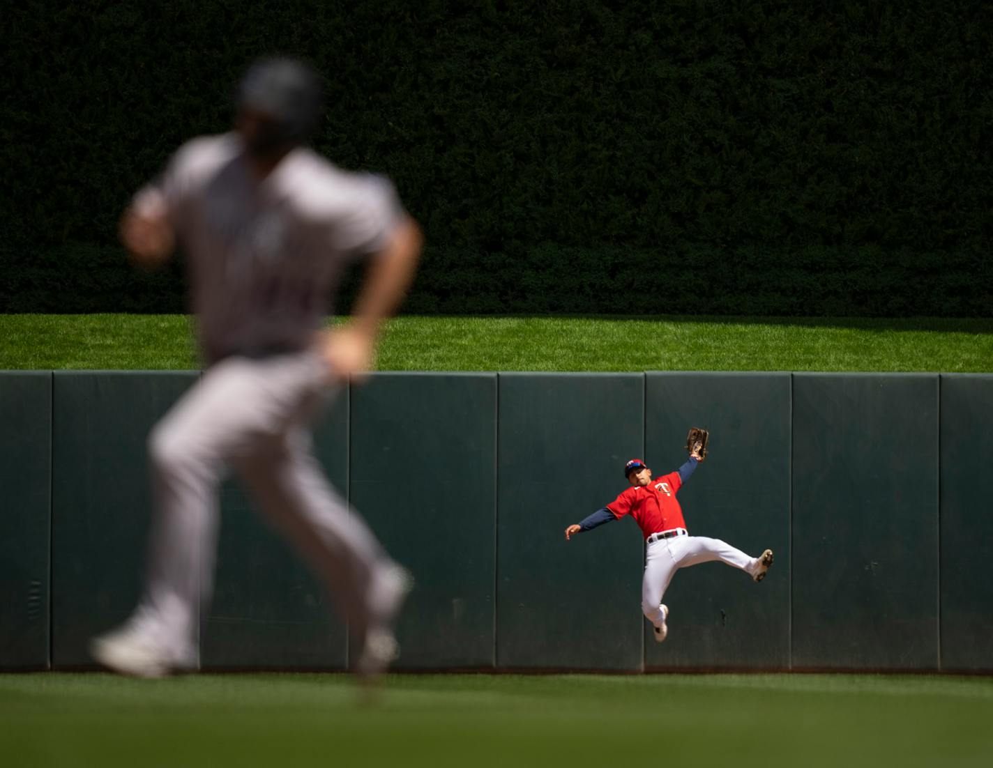 Colorado Rockies third baseman Elehuris Montero (44) flied out to Minnesota Twins center fielder Mark Contreras (55) in the fifth inning as the Rockies' C.J. Cron (25) headed to third base Sunday afternoon, June 26, 2022 at Target Field in Minneapolis. The Minnesota Twins faced the Colorado Rockies in an interleague MLB baseball game. ] JEFF WHEELER • Jeff.Wheeler@startribune.com