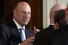 FILE -- Gary Cohn, President Donald Trump's top economic adviser, chats with colleagues before the start of a news conference at the White House on Fe