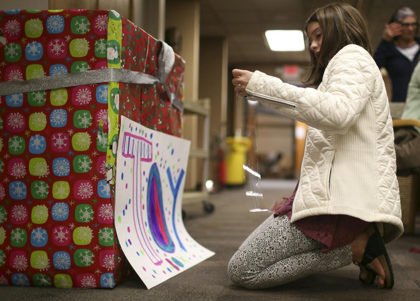 Gracie Tilney-Kaemmer, 12, taped a sign on the large box she decorated for toy donations at the International Institute of Minnesota in St. Paul Tuesday afternoon. ] JEFF WHEELER &#xef; jeff.wheeler@startribune.com An outpouring of donations from individuals eager to help have been pouring in to the International Institute of Minnesota in St. Paul continuously this week. Much of outpouring is in direct response to statements by some elected officials elsewhere who have sought to restrict their s