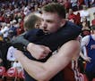 Wisconsin forward Micah Potter, right, hugs Wisconsin head coach Greg Gard after defeating Indiana 60-56 in an NCAA college basketball game in Bloomin