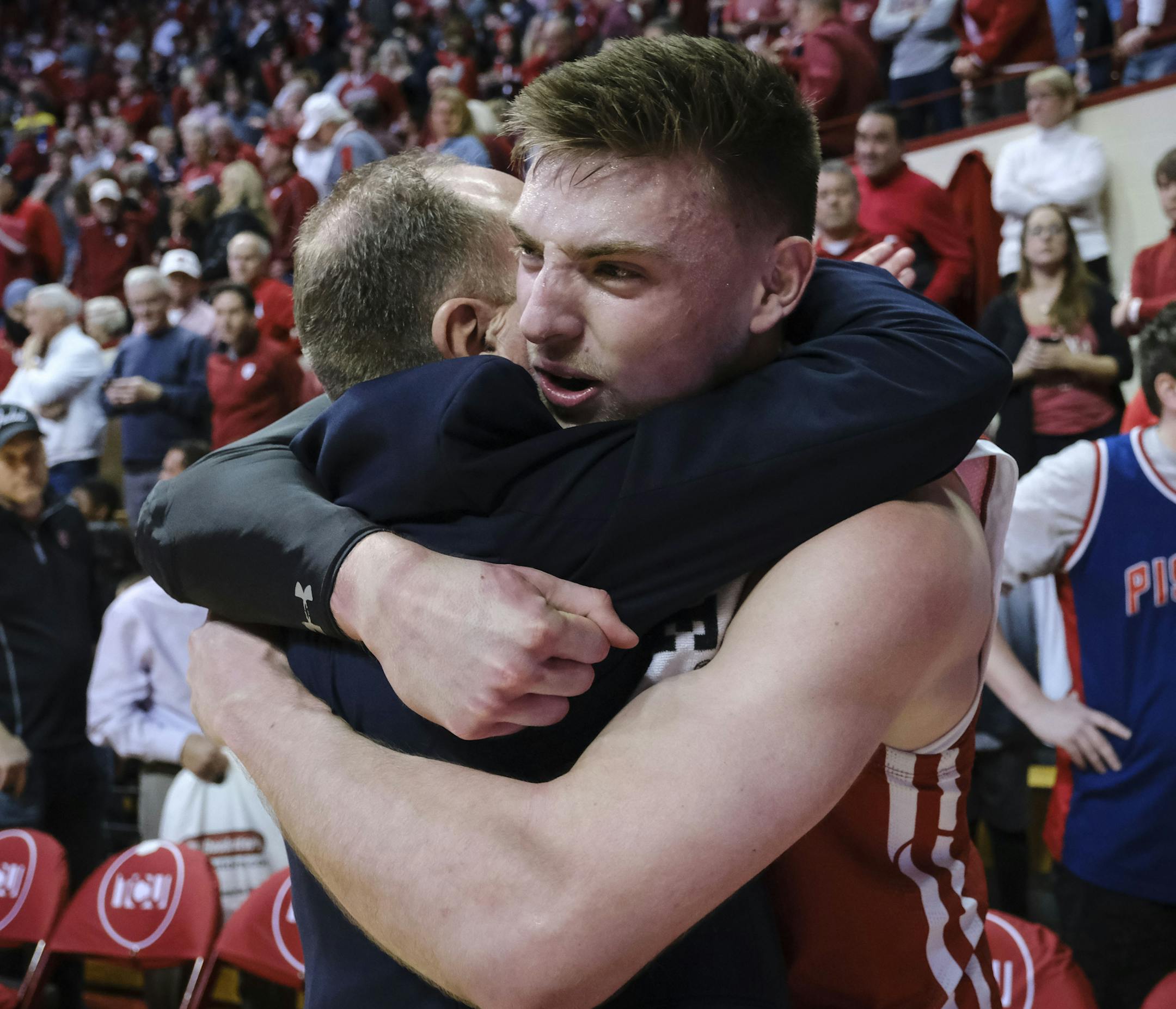 Wisconsin forward Micah Potter, right, hugs Wisconsin head coach Greg Gard after defeating Indiana 60-56 in an NCAA college basketball game in Bloomington, Ind., Saturday, March 7, 2020. (AP Photo/AJ Mast)