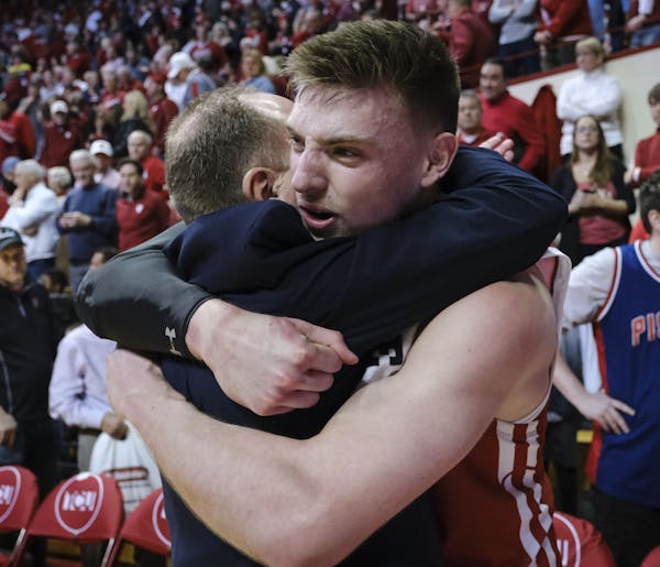 Wisconsin forward Micah Potter, right, hugs Wisconsin head coach Greg Gard after defeating Indiana 60-56 in an NCAA college basketball game in Bloomin
