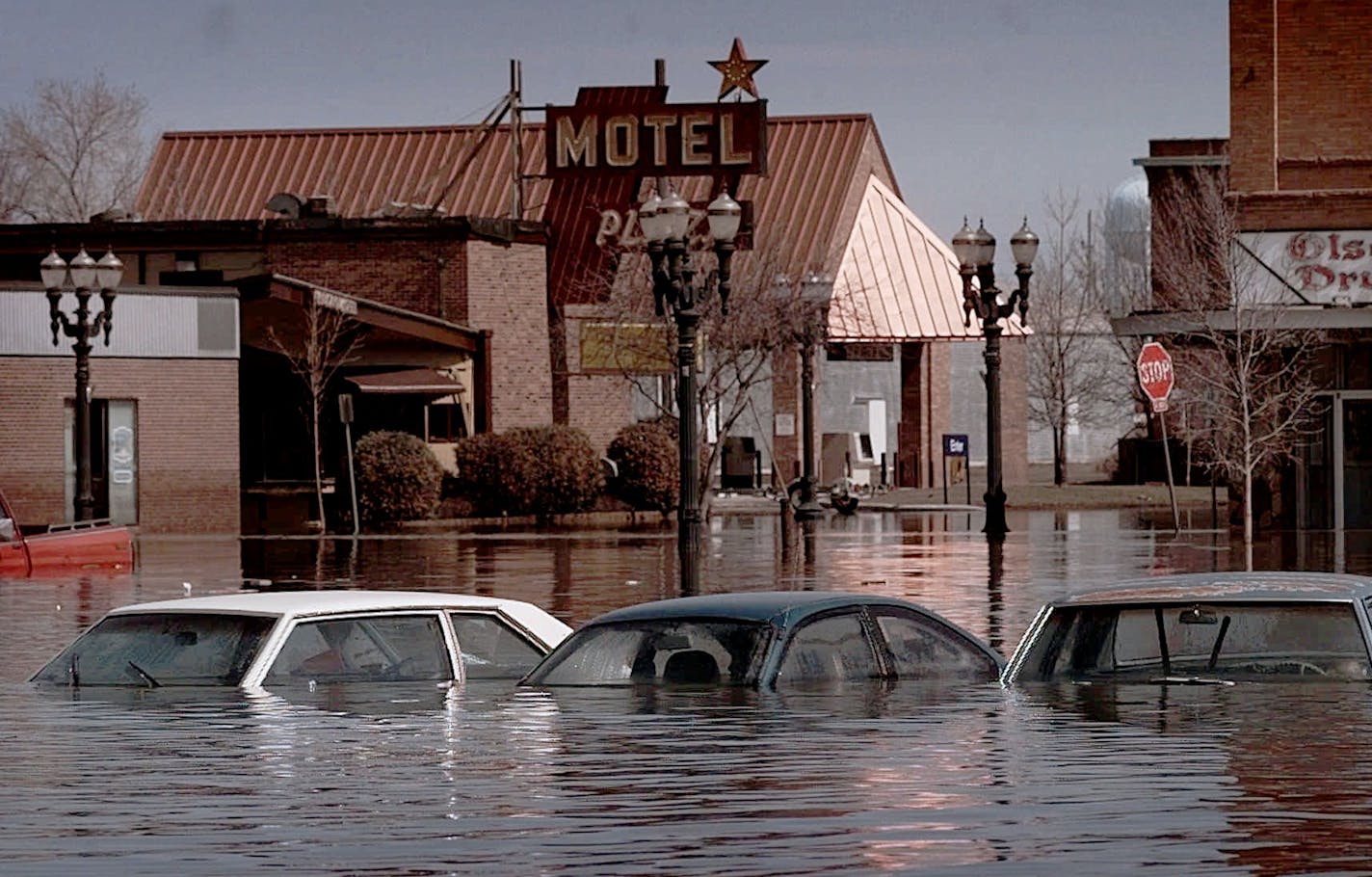 ** ADVANCE FOR WEEKEND APRIL 7-8 ** FILE ** Abandoned cars remain submerged in downtown East Grand Forks, Minn., April 25, 1997, as the waters of the nearby Red River slowly receded. Mayor Lynn Stauss had to be picked up by boat in order to declare a disaster. Ten years later, residents in East Grand Forks and neighboring Grand forks, N.D. have rebuilt their lives. (AP Photo/John Gaps III,file) ORG XMIT: MP103 ORG XMIT: MIN2015031118195560