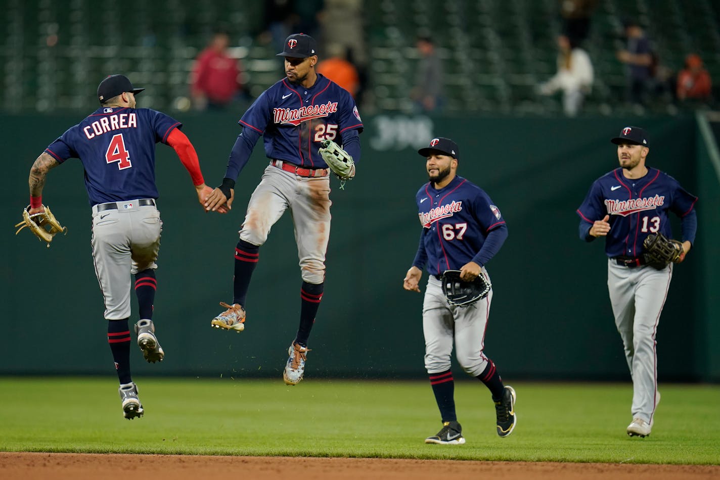 Minnesota Twins' Carlos Correa (4), Byron Buxton (25), Gilberto Celestino (67) and Trevor Larnach (13) during the ninth inning of a baseball game against the Baltimore Orioles, Tuesday, May 3, 2022, in Baltimore. The Twins won 7-2. (AP Photo/Julio Cortez)