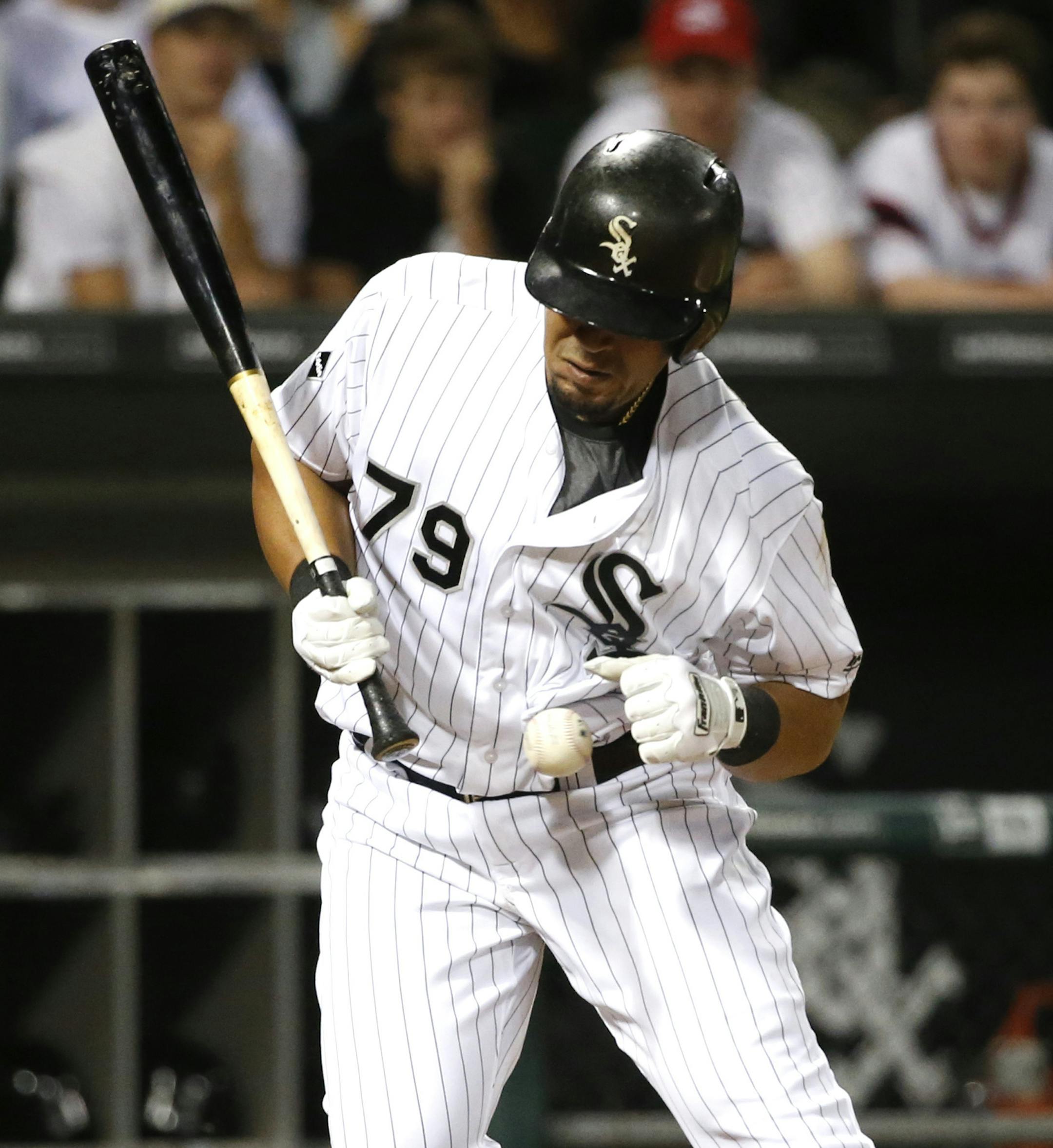 Chicago White Sox's Jose Abreu reacts after being hit by a pitch from Minnesota Twins relief pitcher Trevor May during the ninth inning of a baseball game Friday, May 6, 2016, in Chicago. (AP Photo/Charles Rex Arbogast)