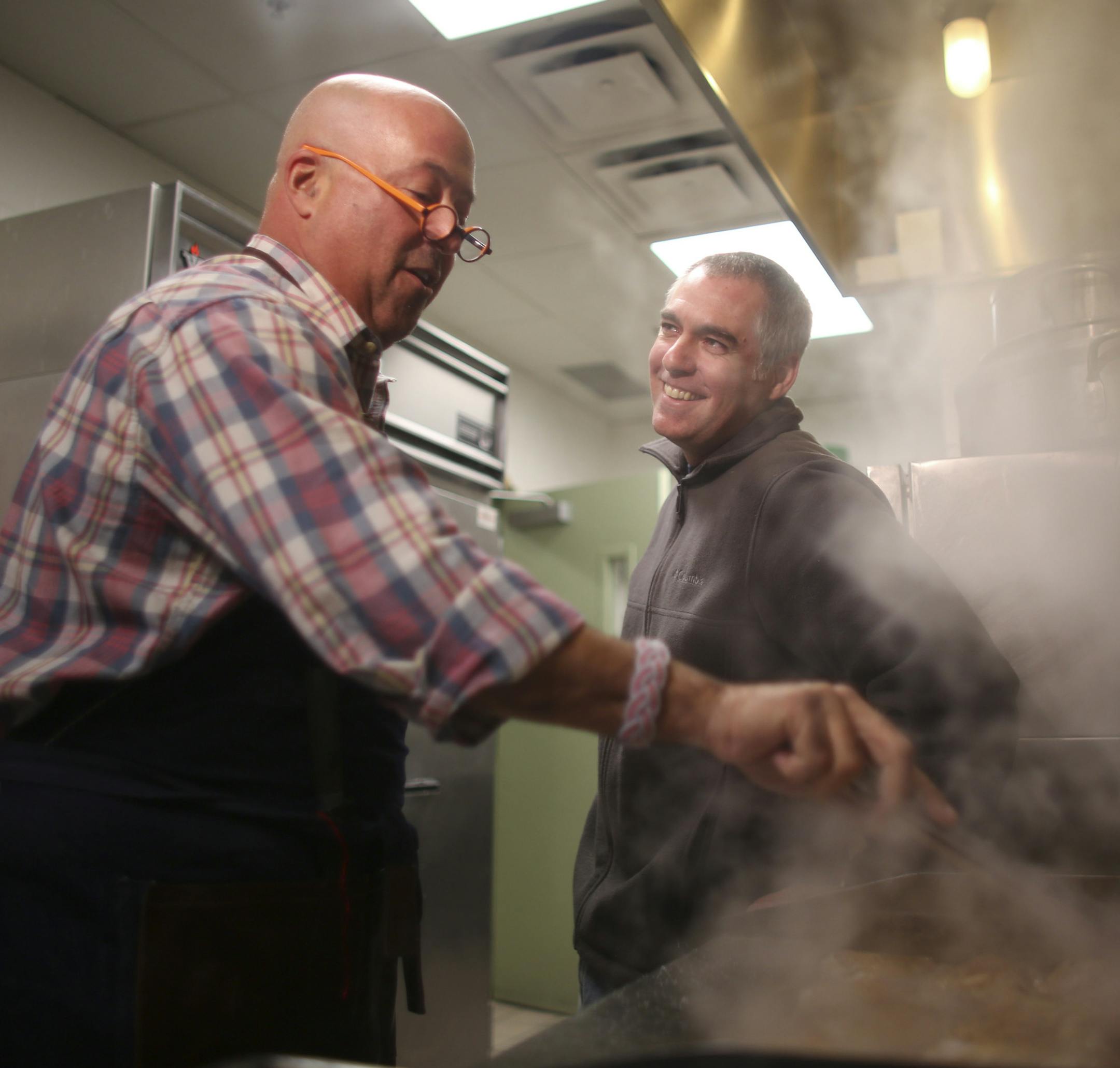 Travel Channel host (and Twin Cities resident) Andrew Zimmern stopped by the Salvation Army's Payne Ave. location in St. Paul to cook with chef Jeff Ansorge, former head chef at the Captal Grille in Minneapolis, as he prepared a meal Monday afternoon, March 3, 2014 for donors and volunteers. Andrew Zimmern jumped right in and started frying chicken as he and Jeff Ansorge caught up in the kitchen at the Salvation Army's Eastside Corps. Community Center Monday afternoon. Zimmern told Ansorge that