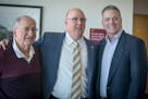 Bob Motzko, the new Gophers hockey coach, center, was given some pointers from former hockey head coaches including Doug Woog, left, and Don Lucia, ri