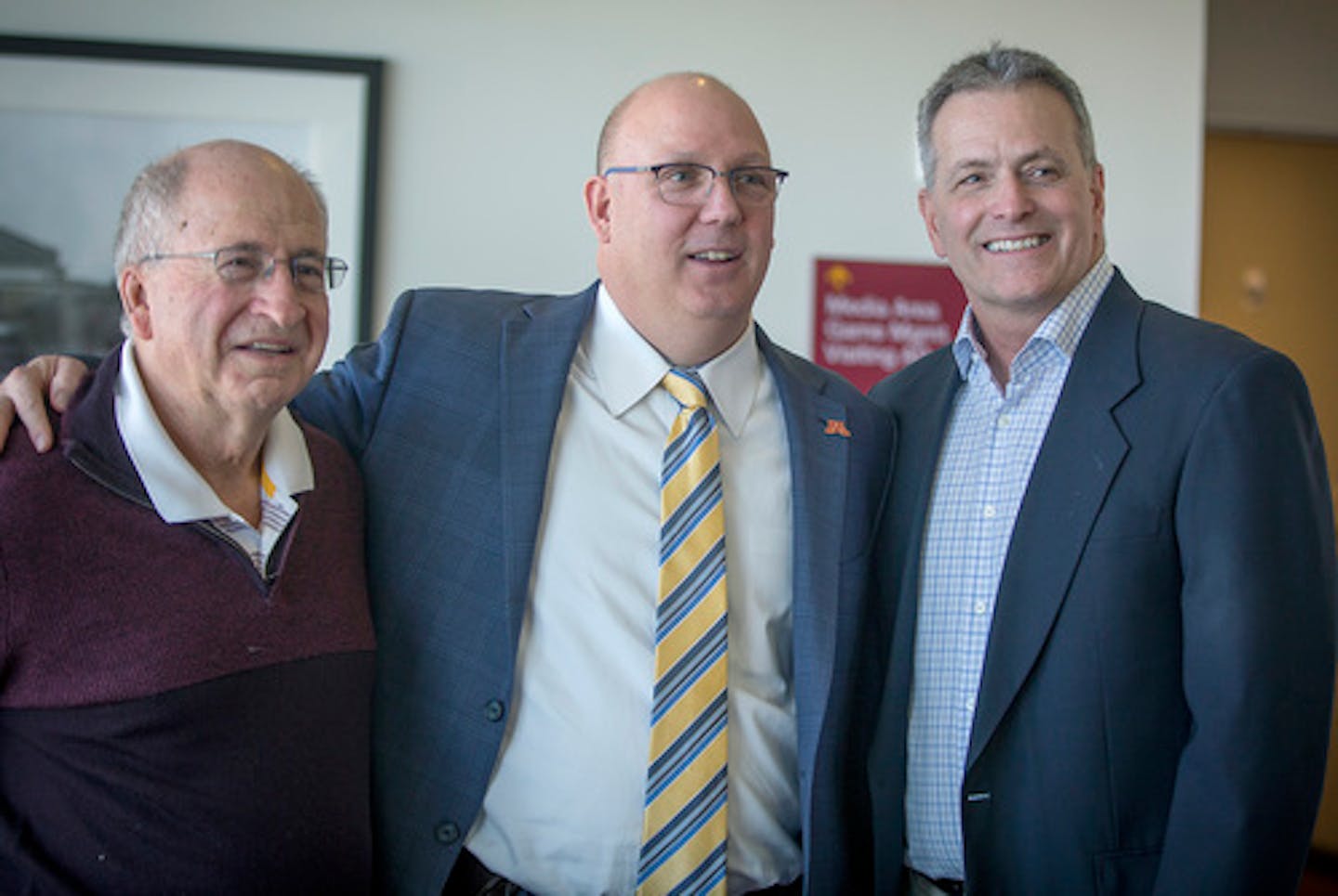 Bob Motzko, the new Gophers hockey coach, center, was given some pointers from former hockey head coaches including Doug Woog, left, and Don Lucia, right, after a press conference at TCF Bank Stadium, Thursday, March 29, 2018 in Minneapolis.