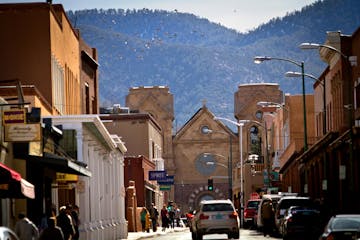 A view on East San Francisco Street in Santa Fe, NM, toward the historic plaza and beyond, to the St. Francis Cathedral Basilica and the foothills of