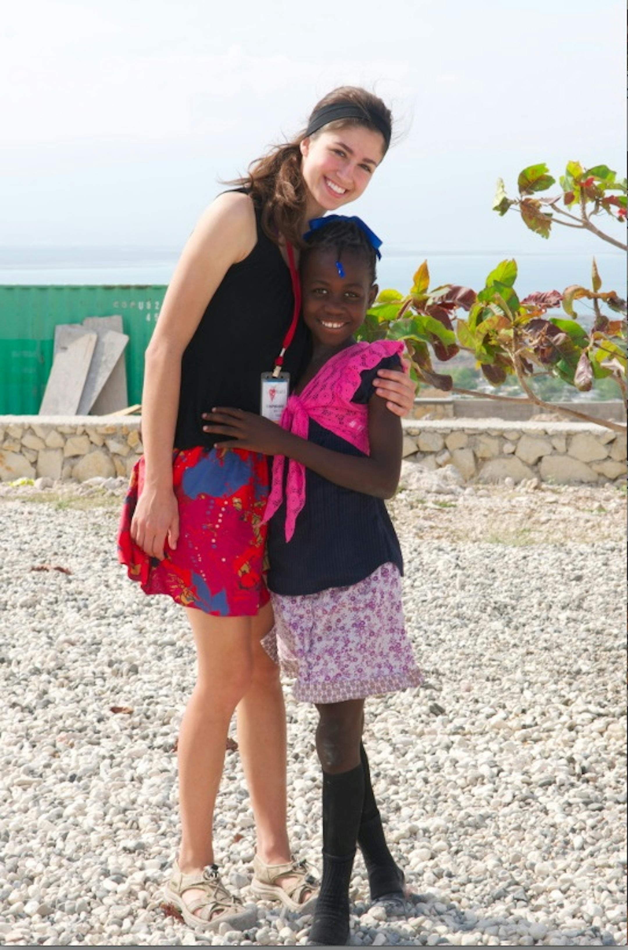 Amanda Sexson, founder of Hearts4Charity, shown with a girl in Haiti.