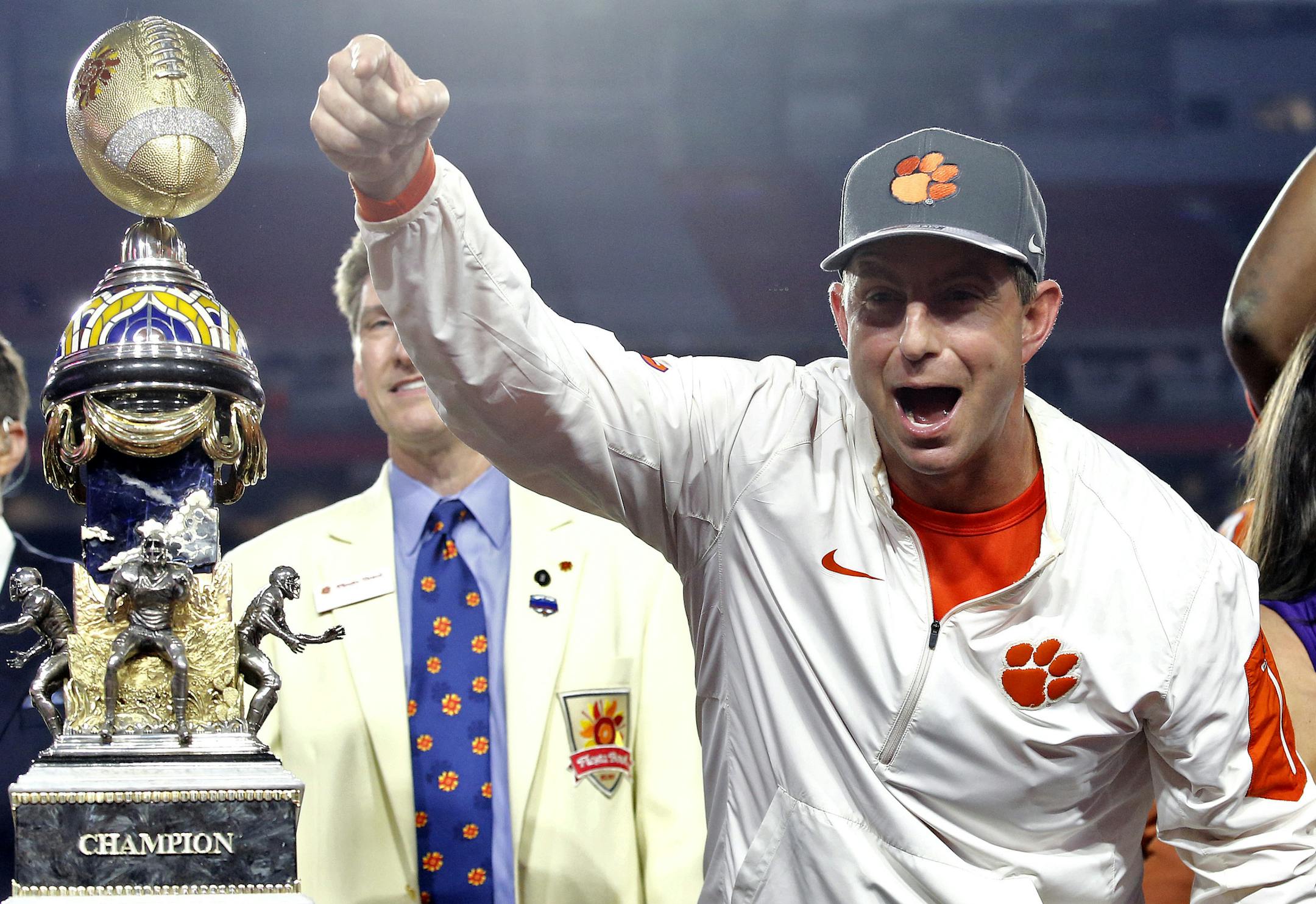 Clemson coach Dabo Swinney celebrates after the team's Fiesta Bowl NCAA college football playoff semifianl against Ohio State, Saturday, Dec. 31, 2016, in Glendale, Ariz. Clemson won 31-0 to advance to the BCS championship game Jan. 9 against Alabama. (AP Photo/Ross D. Franklin)