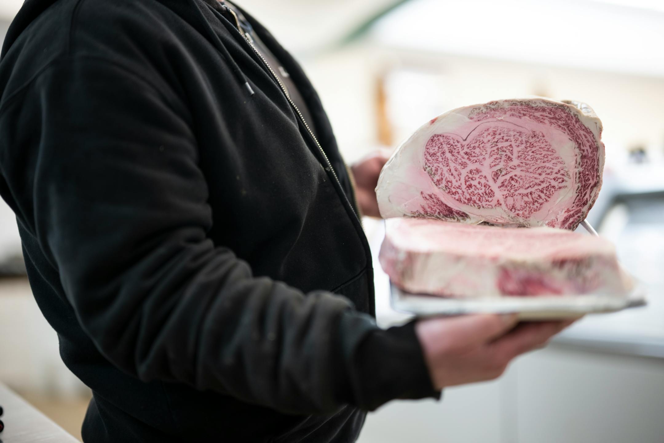 Lonsdale Country Market's second-generation owner Michael Wallin carries a tray of A5 Wagyu beef that he's putting out for sale.