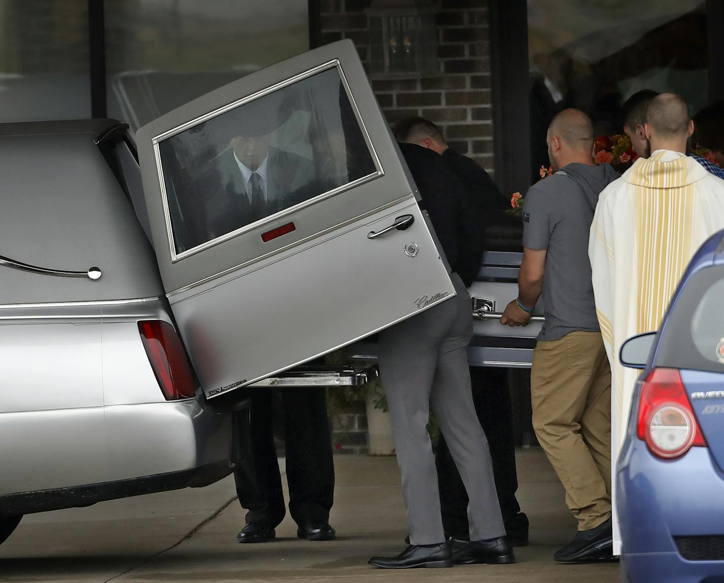 A casket was brought out after the funeral service Oct. 27, 2018, for James and Denise Class at St. Peter's Catholic Church in Cameron, Wis.