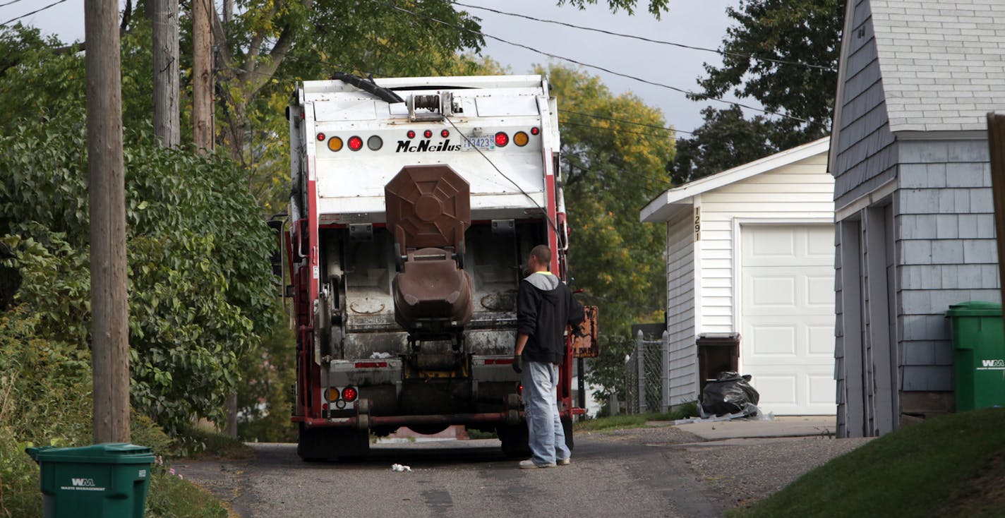 KYNDELL HARKNESS &#x2022; kharkness@startribune.com 9/29/09St. Paul has a lot of garbage companies[With Waste Management cans on either side, Gene's Disposal Service worker emptied out one of the trash cans near Wheelock and Grotto in St. Paul. The city has more thn a dozen different companies the provide garbage service.