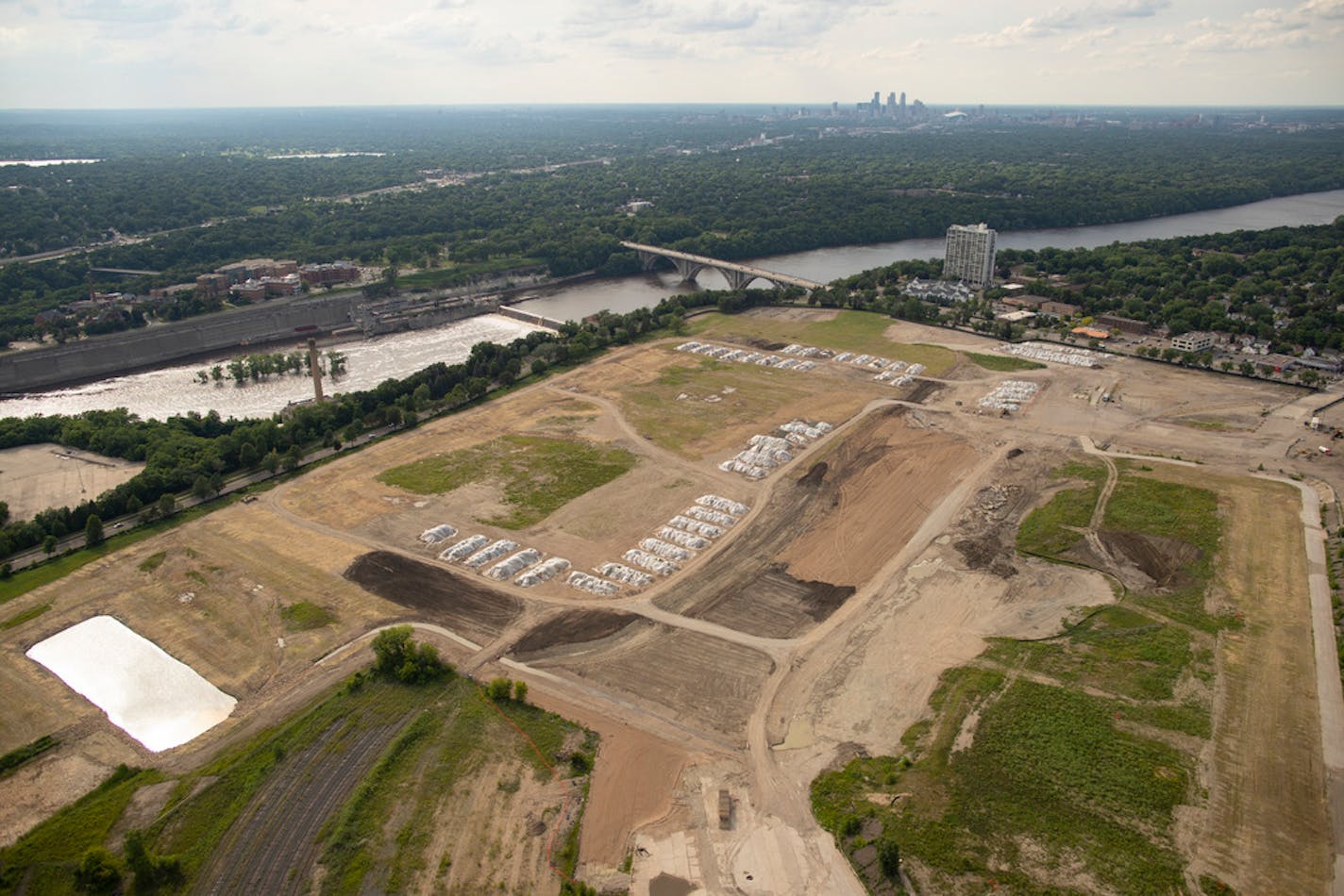 The former Ford assembly plant site, looking northwest, with the downtown Minneapolis in the background. Area C is a 22-acre parcel along the Mississippi River that Ford used as a dump site for generations.