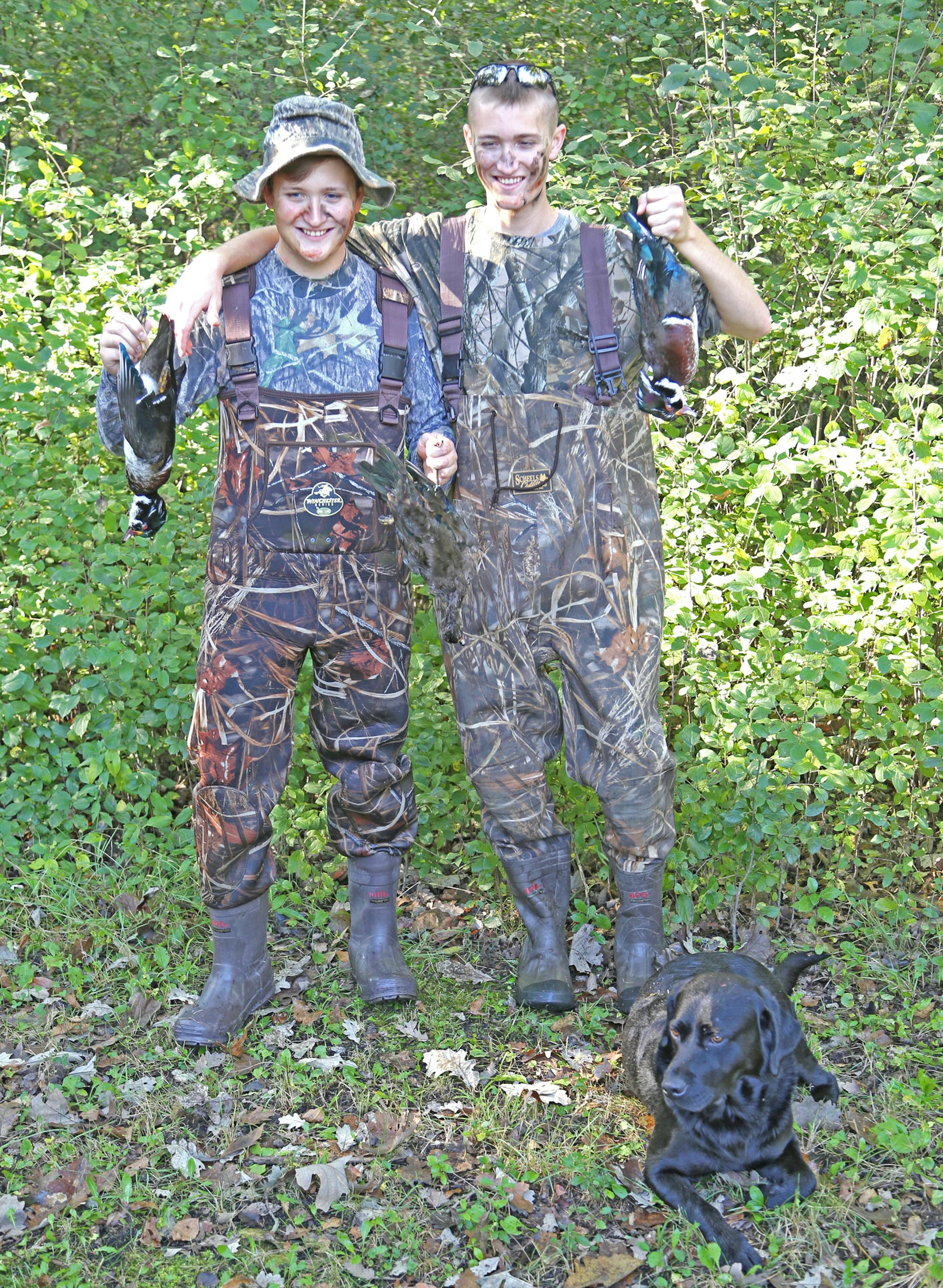 Wood ducks in hand, brothers Matthew, left, and Harrison Smith returned from separate colleges on Saturday to join family and friends on the duck opener near Sacred Heart. Matthew attends the University of Minnesota-Morris. Harrison is at the University of South Dakota.
