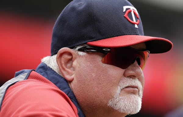 Minnesota Twins manager Ron Gardenhire watches play from the dugout in the fourth inning of a baseball game, Saturday, June 28, 2014, in Arlington, Te