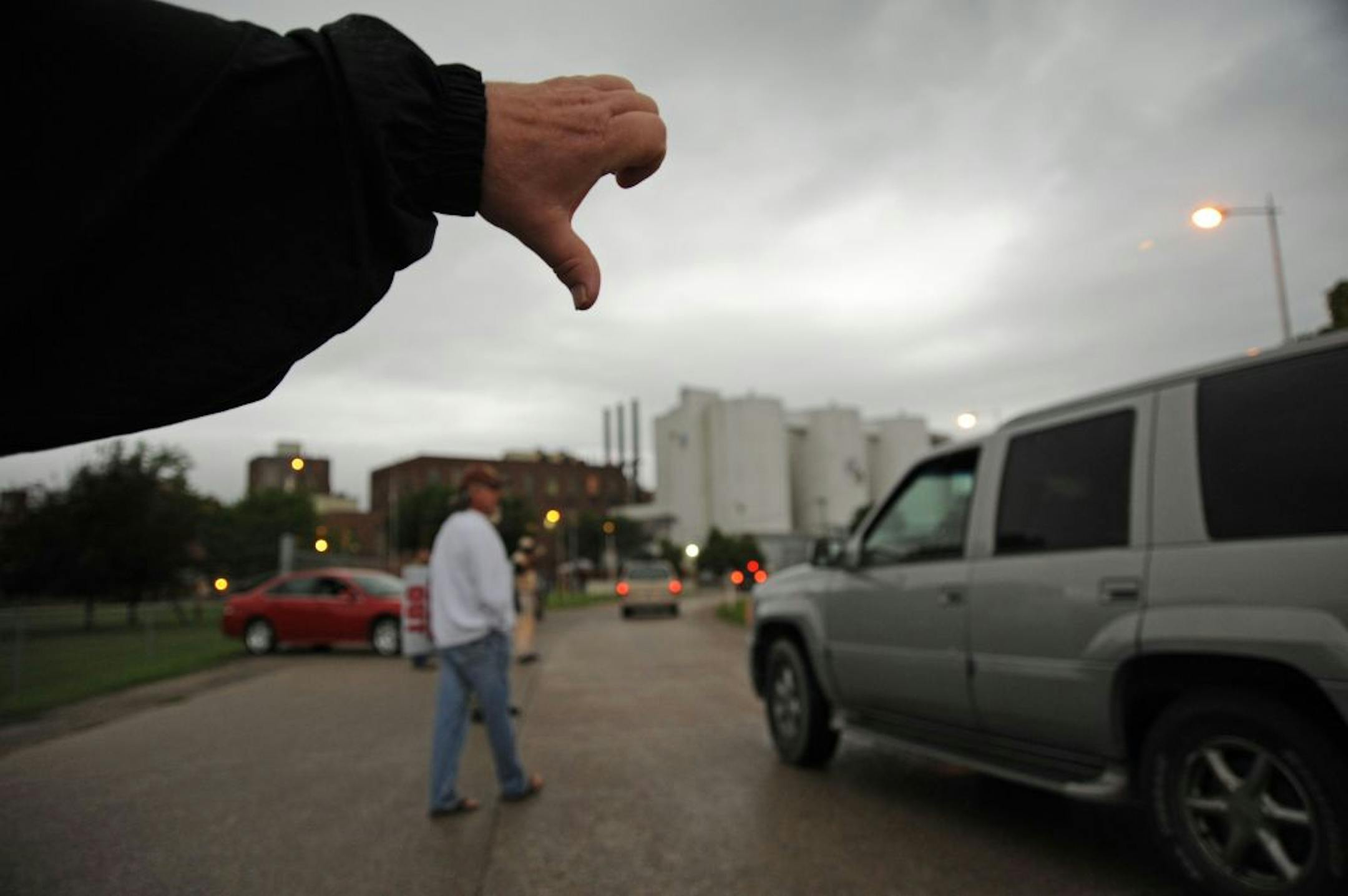 Union workers pointed thumbs down and picketed in front of the main gate for Crystal Sugar in Crookston, Minn., as out-of-state non-union workers arrived to replace local union workers.