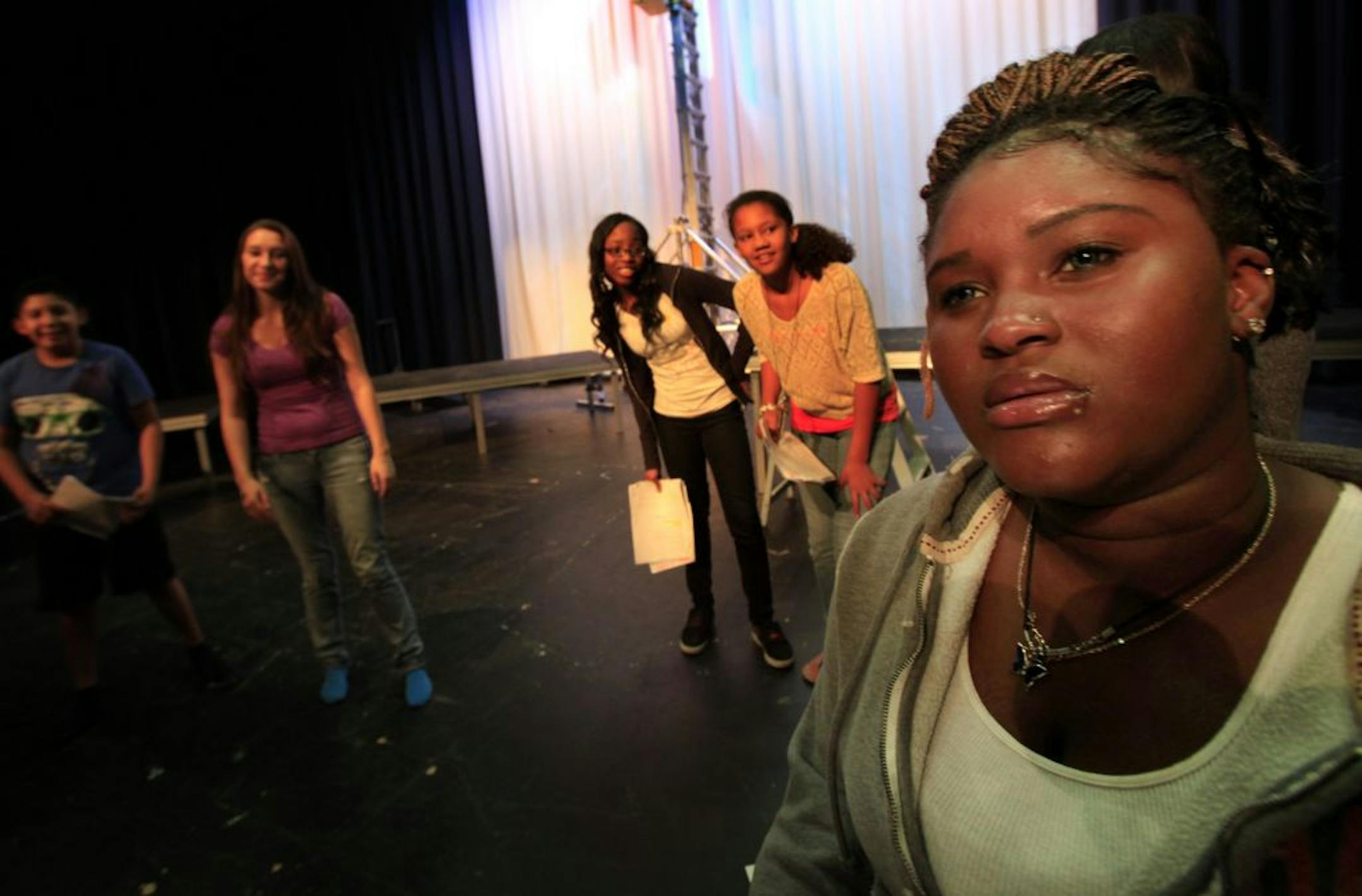 Left to right: Students Bruce Aguilar ( background, blue shirt, 7th grade), Dacia Mitchell ( left with purple shirt, 11th grade), Ashley Koudou ( white shirt wth black sleeves, 10th grade0, Melodie Hunt (8th grade, brown shirt ) and Grace Bockarie ( right closeset to camera, 9th grade) practice a scene in a play at Brooklyn Center High School. Students Bruce Aguilar (Brooklyn Center, MN on September 19, 2012.