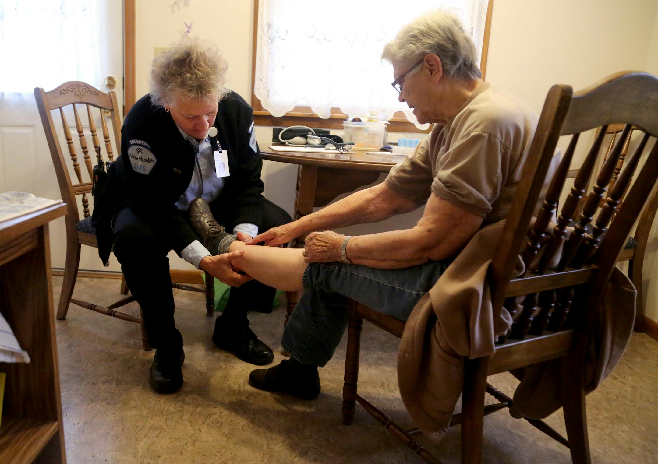Allina paramedic Diane Bauer checked on cardiac patient Ann Losness at her home to make sure she is OK and at low risk of going back to the hospital.