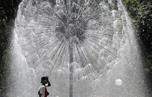 The Berger Fountain, also known as the Dandelion Fountain, in Loring Park glistened in the bright sunlight behind Chyna Porter as she enjoyed an after