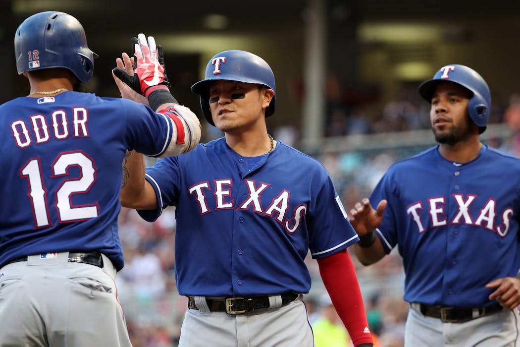 Texas Rangers second baseman Rougned Odor (12) celebrates with Shin-Soo Choo and Elvis Andrus