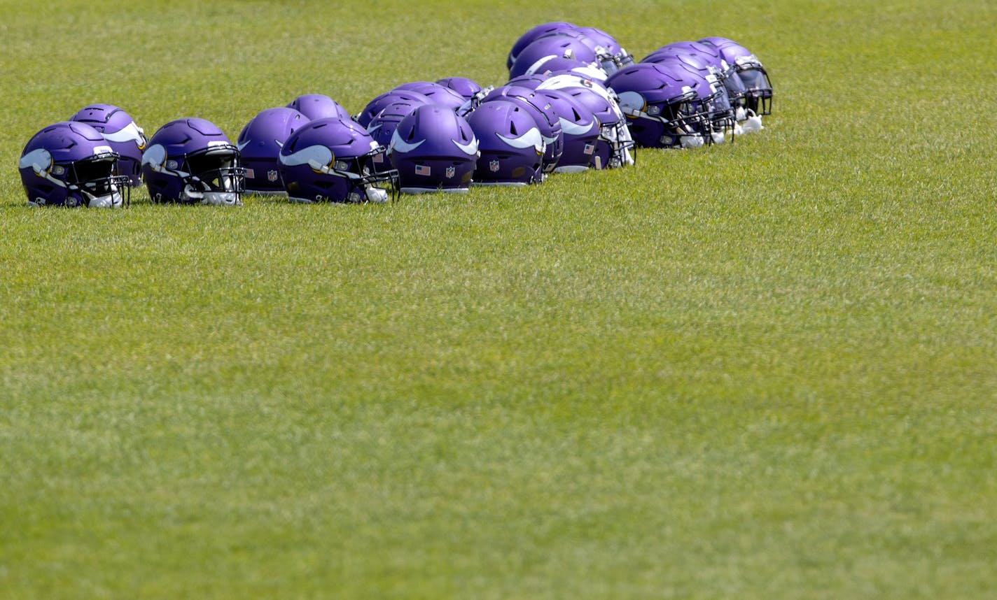 Helmets on the turf during Minnesota Vikings OTAs scrambles Wednesday, June 9, 2021, in Eagan, Minn. (Carlos Gonzalez/Star Tribune)