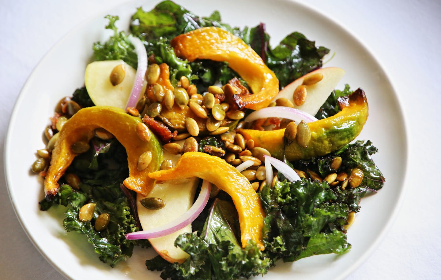 Kale and Roasted Squash Salad With Spiced Pumpkin seeds.