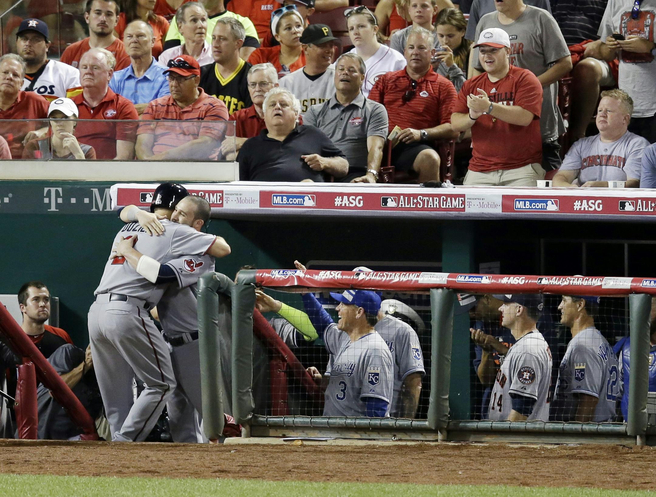 American League's Brian Dozier, of the Minnesota Twins, is hugged by American League's Jason Kipnis,of the Cleveland Indians, after hitting a home run during the eighth inning of the MLB All-Star baseball game, Tuesday, July 14, 2015, in Cincinnati. (AP Photo/Michael E. Keating )