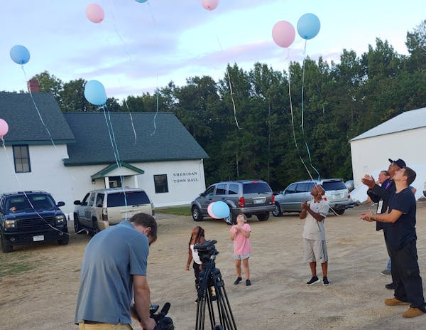 Peace activist KG Wilson, wearing the hat, released balloons Wednesday near the spot where four people were found slain. Damone Presley, Sr., the fath
