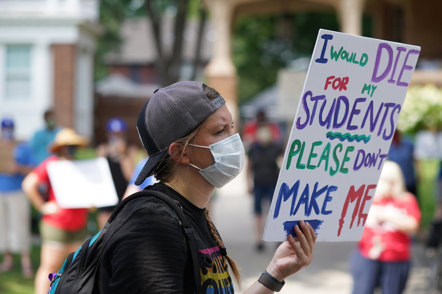 Grace Leary, a paraeducator who works with kindergarten through third grade students with learning disabilities last week held a sign as she and others protested in-person learning this fall outside of the Governor's Residence in St. Paul. ] ANTHONY SOUFFLE • anthony.souffle@startribune.com