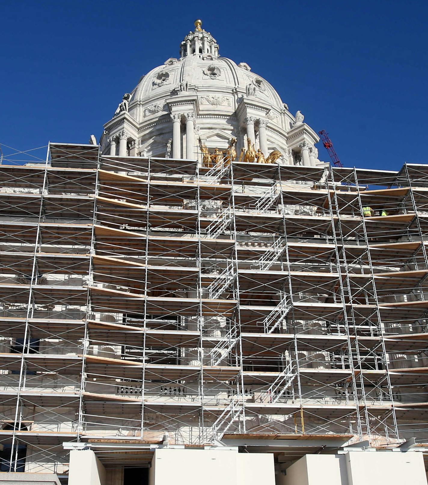 ADVANCE FOR SUNDAY, NOV. 30 2014, AT 12:01 A.M. CST. AND THEREAFTER- In this photo taken Tuesday, Nov. 25, 2014, protective wrap covering, left, and scaffolding hid the graceful lines of the Minnesota state Capitol as the massive renovation continues in St. Paul, Minn. The working sections of the building have been so disrupted by the overhaul that lawmakers will find the going tough this upcoming session. (AP Photo/Jim Mone)