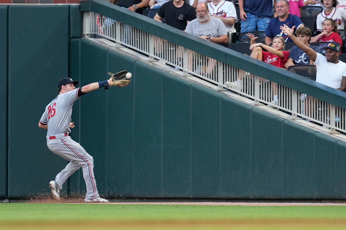 Minnesota Twins right fielder Max Kepler (26) catches a fly ball hit by Atlanta Braves' Orlando Arcia in the third inning of a baseball game Monday, June 26, 2023, in Atlanta. (AP Photo/John Bazemore)