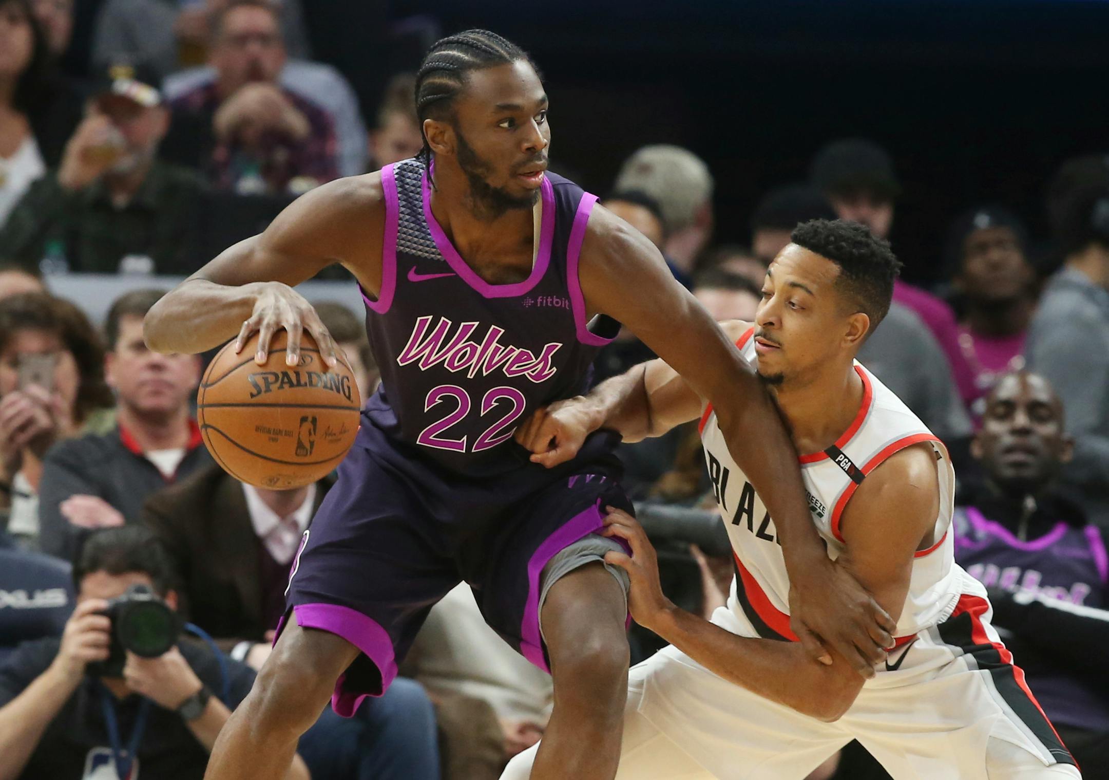 The Timberwolves' Andrew Wiggins, left, drives against Portland Trail Blazers' CJ McCollum during the first half