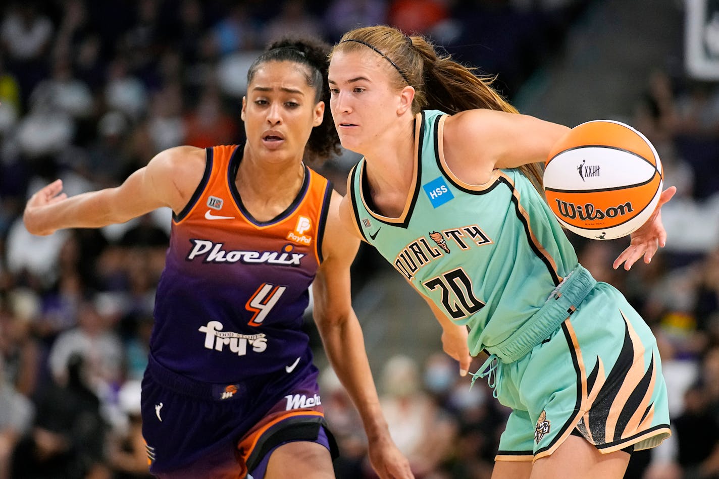 New York Liberty guard Sabrina Ionescu (20) drives past Phoenix Mercury guard Skylar Diggins-Smith during the second half in the first round of the WNBA basketball playoffs, Thursday, Sept. 23, 2021, in Phoenix. Phoenix won 83-82. (AP Photo/Rick Scuteri)