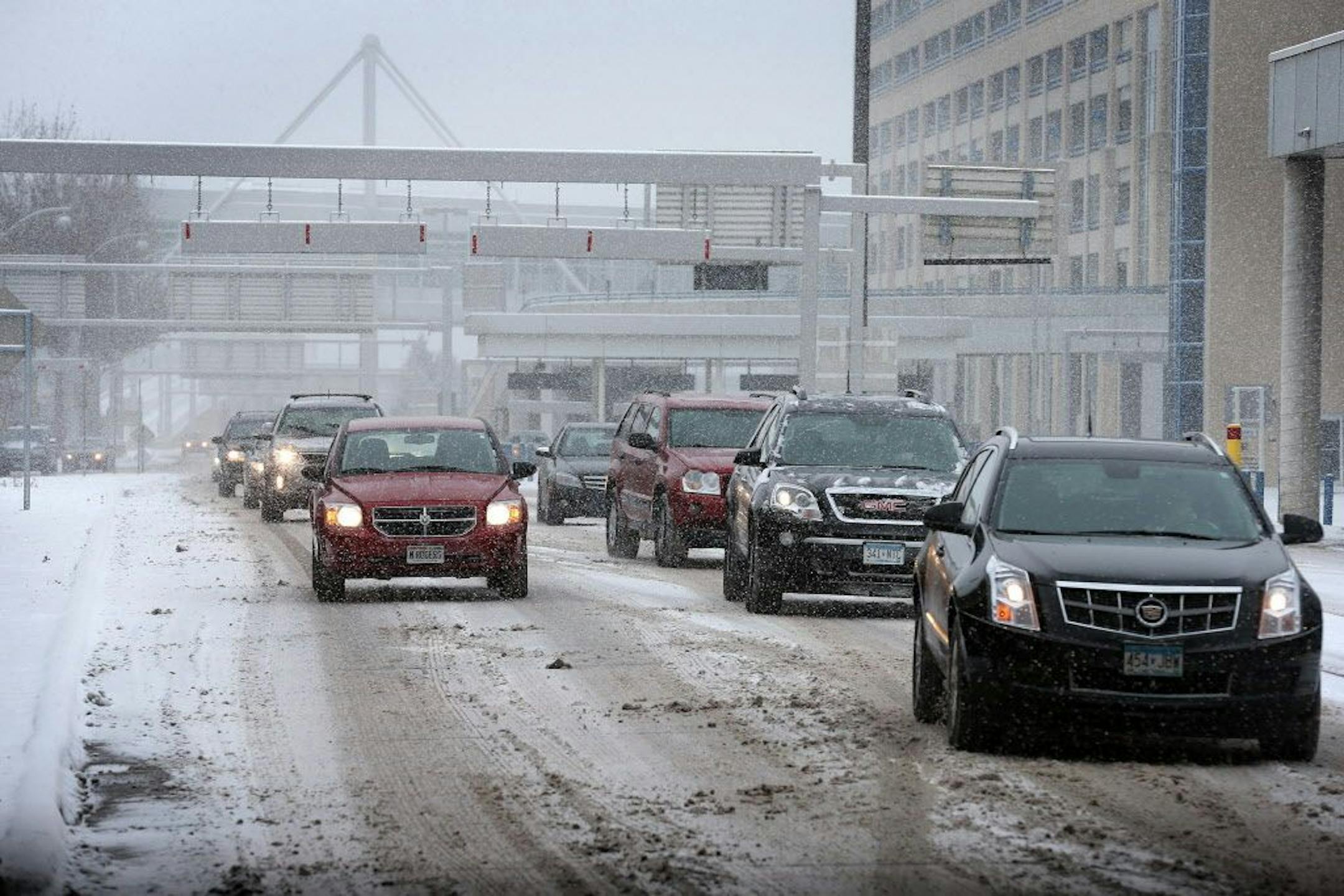 Cars enter the curbside pick-up area at Minneapolis-St. Paul International Airport Terminal 1 on Wednesday, November 26, 2014.