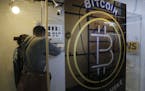 In this Friday, Dec. 8, 2017, photo, people use the Bitcoin ATM in Hong Kong. The launch of a U.S. futures contract for bitcoin on Sunday, Dec. 10, 20