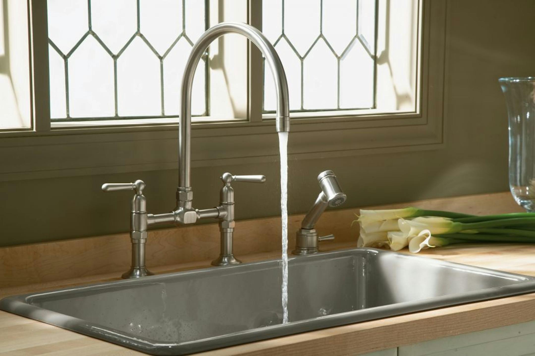 Getting a new kitchen faucet with a longer spout to help ease your backache is well worth the money.