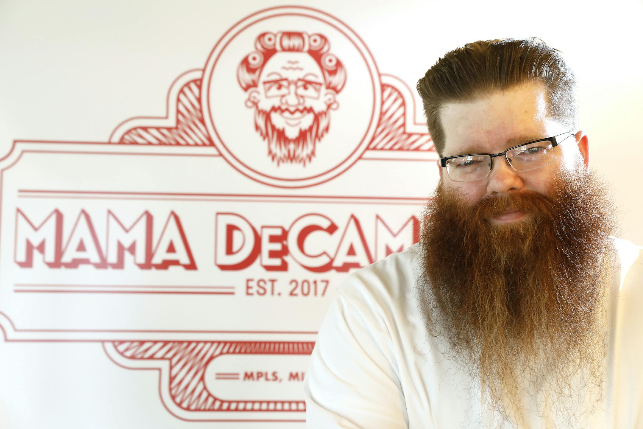 Chef Mike DeCamp in front of a sign for their Sunday night dinner.