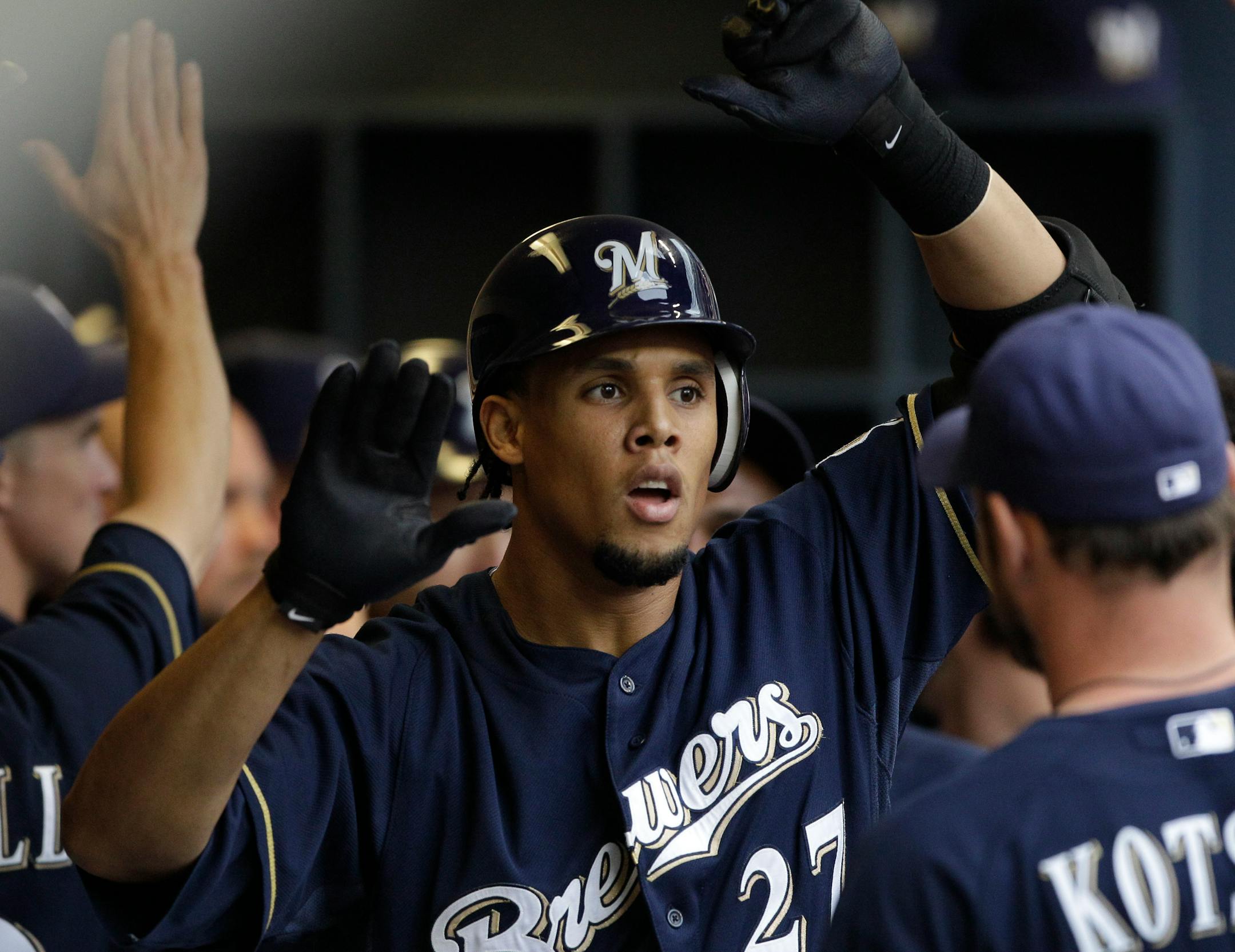 Milwaukee Brewers' Carlos Gomez is congratulated in the dugout after hitting a two-run home run during the third inning of a baseball game against the Minnesota Twins on Saturday, June 25, 2011, in Milwaukee. (AP Photo/Morry Gash)