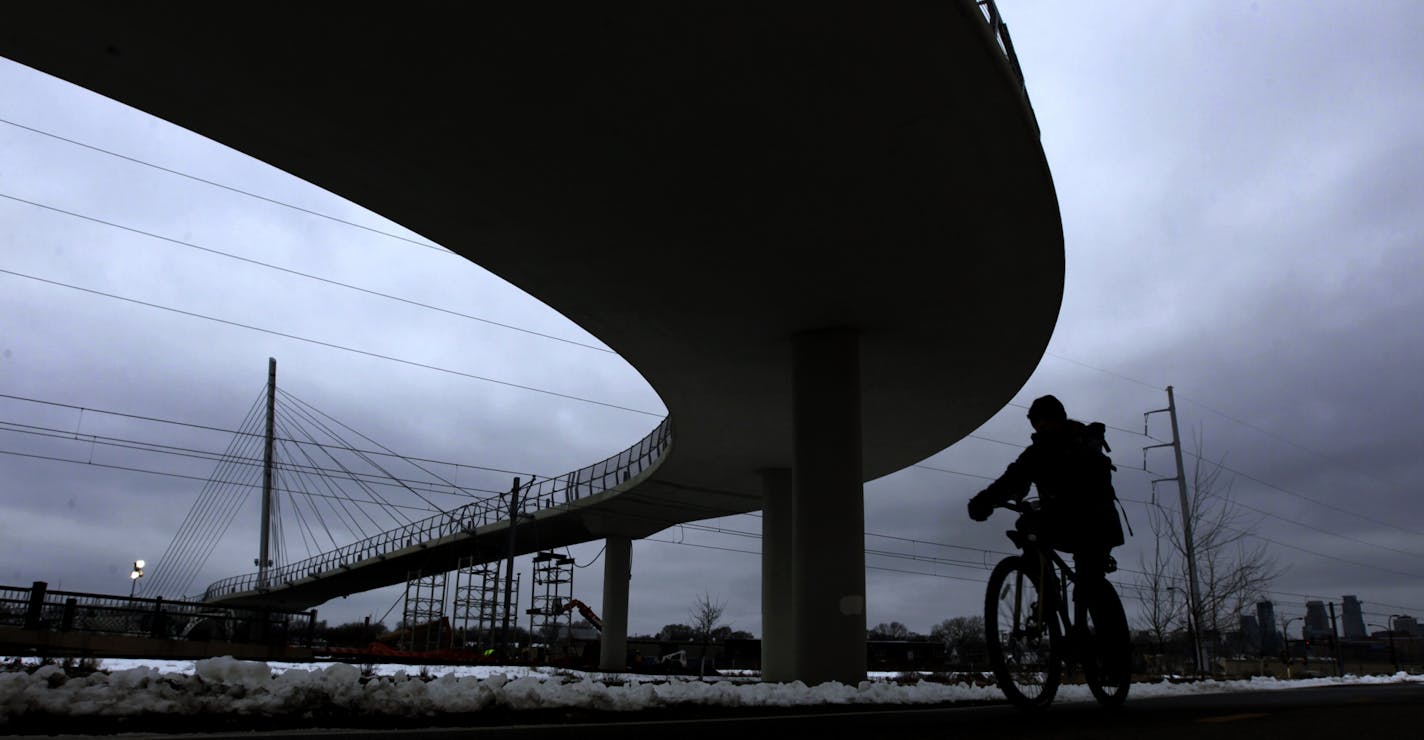 A cyclist rode along the bike trail near the Martin Sabo Bridge.