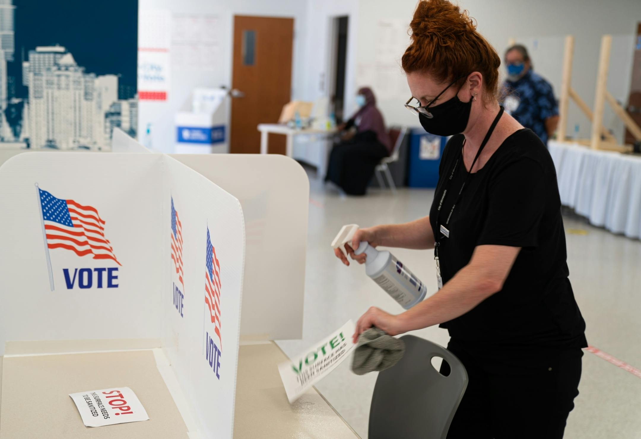 Election worker Jennifer Johnson sanitized voting stations between voters at the Minneapolis Early Vote Center.