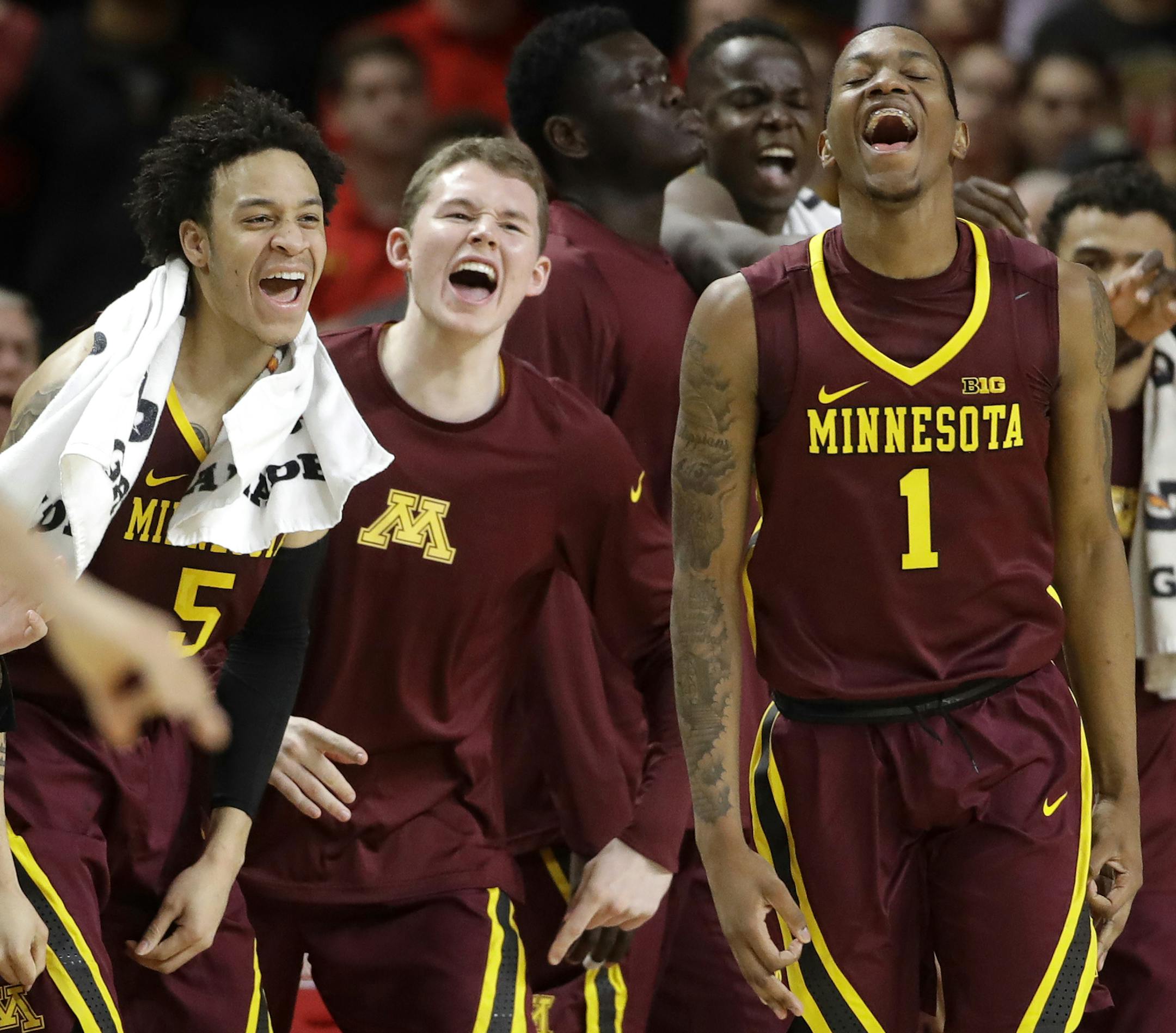 Minnesota guard Dupree McBrayer (1) reacts in front of teammates after making a 3-pointer during the second half of the team's NCAA college basketball game against Maryland, Wednesday, Feb. 22, 2017, in College Park, Md. Minnesota won 89-75. (AP Photo/Patrick Semansky)