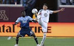 Minnesota United defender Kevin Venegas, right, and Vancouver Whitecaps forward Alphonso Davies (67) compete for the ball during the second half of an