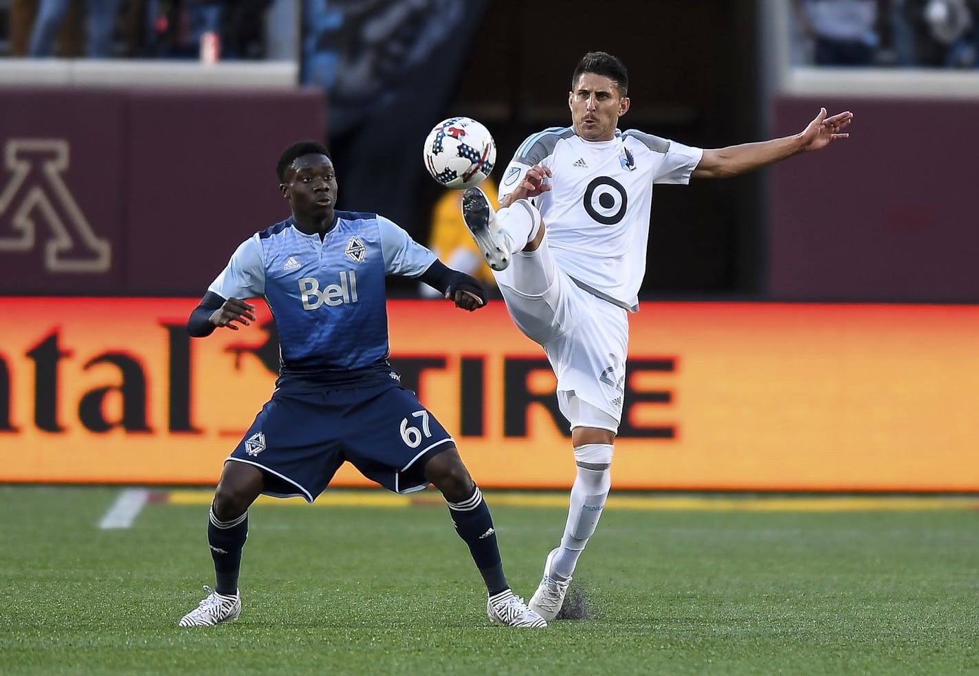 Minnesota United defender Kevin Venegas, right, and Vancouver Whitecaps forward Alphonso Davies (67) compete for the ball during the second half of an MLS soccer match Saturday, June 24, 2017, in Minneapolis. (Aaron Lavinsky/Star Tribune via AP)