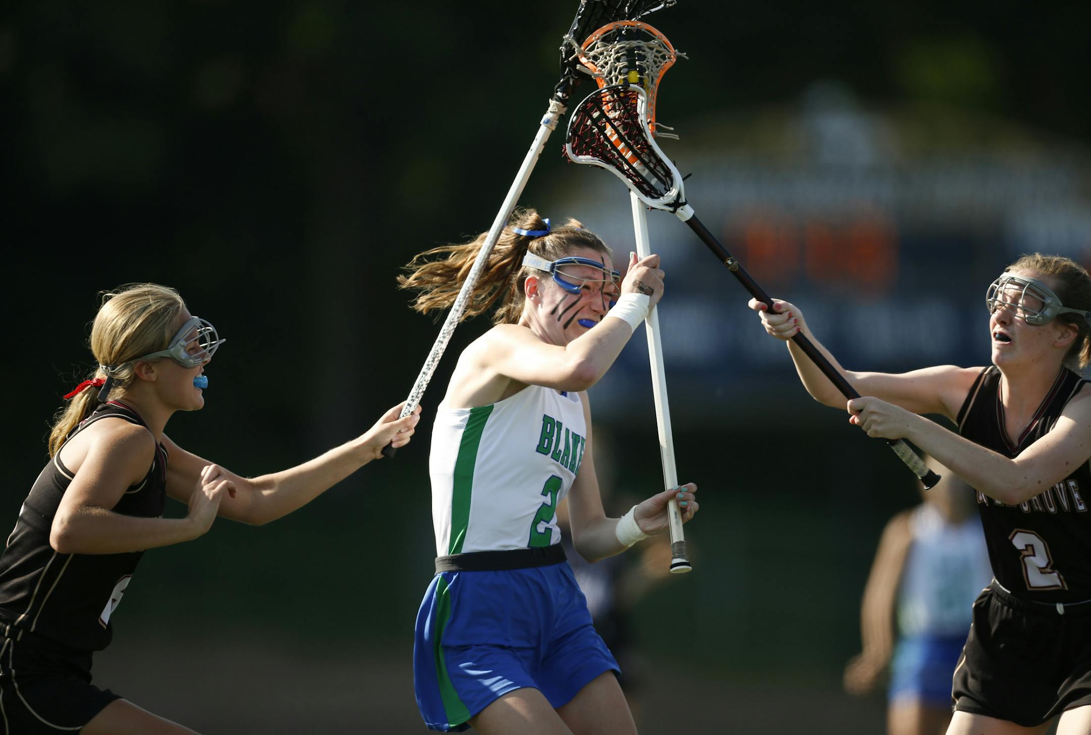 Blake's Anne Slusser drove between a pair of Maple Grove defenders, Breanna Blesi, left, and Sydney Kara on her way to a first half goal Tuesday evening at Chanhassen High School. ] JEFF WHEELER ‚Ä¢ jeff.wheeler@startribune.com Blake and Maple Grove met in a girl's state lacrosse quarterfinal game held Tuesday evening, June 10, 2014 at Chanhassen High School. Blake led 14-1 at halftime.